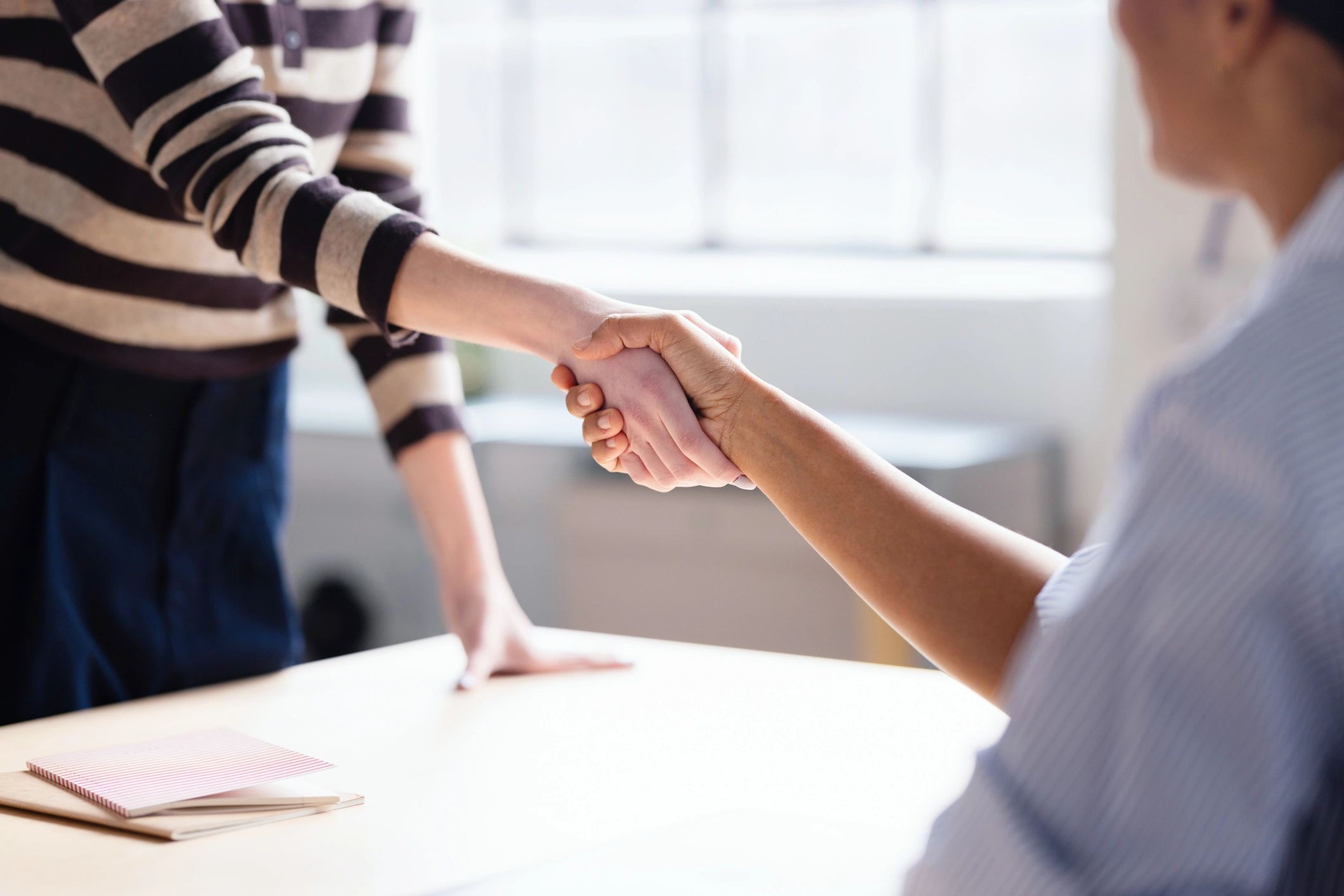 Professional handshake between investment partners in an office